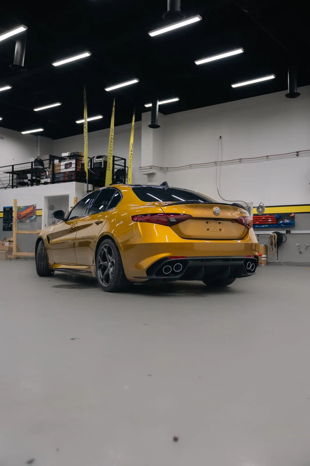 A gold Alfa Romeo Giulia Quadrifoglio inside the AutoPlex studio